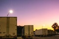 Big rig semi trucks and trailers at rest area at sunrise Royalty Free Stock Photo