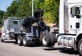 Big rig towing semi truck tow ather semi truck tractor on the road Royalty Free Stock Photo