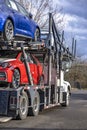 Big rig white car hauler semi truck with loaded semi trailer with cars standing on the parking lot takin a break Royalty Free Stock Photo
