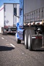 Big rigs semi trucks convoy with different trailers for long and Royalty Free Stock Photo