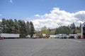 Big rigs semi trucks with different semi trailers standing for truck driver rest on the wide truck stop parking lot Royalty Free Stock Photo