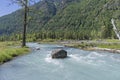 Big rock in the middle of a mountain river.