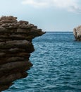 Big rock stacks in the calm blue sea against the blue sky on Corse island in France