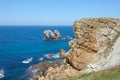 Big rocks in the middle of the sea under a blue sky Royalty Free Stock Photo