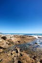 Big rocks in the ocean or sea water with a blue sky background. Beautiful landscape with a scenic view of the beach with Royalty Free Stock Photo