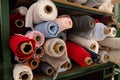Big rolls of colorful fabric stacked on factory shelves ready for production Royalty Free Stock Photo