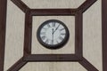 Big round clocks hang on a gray brown building wall Royalty Free Stock Photo