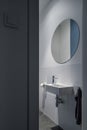 Big, round mirror above small washbasin Royalty Free Stock Photo