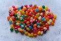 Big round pile of colorful jellybeans on rustic grey background