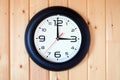 Big round wall clock isolated on wooden wall