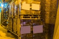 Big row of stacked pallets full of stone tiling, pallets with blank labels, logistics and construction industry background