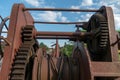 A big rusty pinion mechanism on the deck of an old ferry. Old rusty vintage mooring bollard for boats, ships and yachts. Control