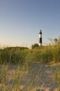 Big Sable Point Lighthouse surrounded by greenery and sand under the sunlight in Michigan Royalty Free Stock Photo