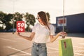 Big sale. Beautiful woman in casual clothes is holding shopping bags, outdoors Royalty Free Stock Photo