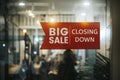 Big sale Closing Down  sign painted on the window of a dress shop Royalty Free Stock Photo