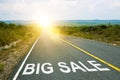 Big sale, concept photo of asphalt road. Motivational inscription on the road going forward. The beginning of a new path. A Royalty Free Stock Photo