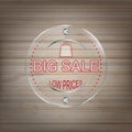 Big sale glass label on a wooden background