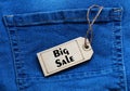 Big Sale tag on blue jean background.