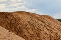 Big sand dune looking as mountain and blue sky with clouds on the background Royalty Free Stock Photo