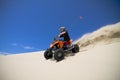 Big sand spray from ATV quadbike rider in the dune Royalty Free Stock Photo