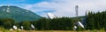 Big satellite dish antennas hidden in green pine tree forest. Satellite Communication Center in Cheia, Prahova, Romania