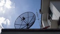 Big Satellite Dish, small red Satellite Dish and Antenna TV on the roof of house against with blue sky and white clouds Royalty Free Stock Photo