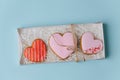 Big scarlet heart cookies in a box casing with filling paper. Top view