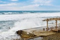 Big sea waves breaking on concrete pier in windy weather Royalty Free Stock Photo