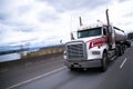 Big semi truck with stainless steel tank trailer on freeway Royalty Free Stock Photo