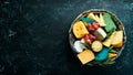 Big set of cheeses with snacks in a wooden box. On a black stone background. Royalty Free Stock Photo