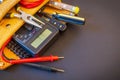 Big set of tools in suede bag on black background prepared by the master electrician before repair or construction