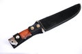 Big sharp hunting knife in a sheath on a white background. Cold weapon of the hunter.