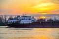 Big ship on the Danube river, big industrial vessel at the border with Ukraine a sunset