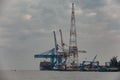 Big ship is loading containers by port cranes in Haiphong container terminal during cloudy weather