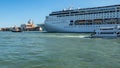 Big ship ship is sailing around historical building in Venice