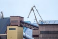 Big shipping dock cranes located in small baltic sea port