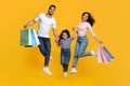 Big Shopping Concept. Overjoyed Arab Family Of Three Jumping With Shopper Bags