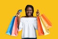 Big Shopping. Joyful Black Woman Posing With Shopper Bags And Credit Card Royalty Free Stock Photo