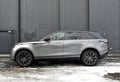 Big silver grey British 4WD compact luxury crossover car Range Rover Velar parked in ice and snow Royalty Free Stock Photo