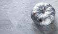 Big silver Pumpkin on table, top view. Thanksgiving day composition on gray background. Autumn harvest concept. Halloween