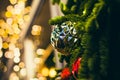 Big silver rough ball on the Christmas tree closeup with yellow bokeh Royalty Free Stock Photo