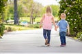 Big Sister and Brother Holding Hands And Walking At The Park Royalty Free Stock Photo