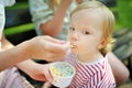 Big sister feeding tasty drops ice cream to her toddler brother Royalty Free Stock Photo