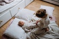 Big sister playing with newborn, little baby. Girl looking at new sibling, holding baby& x27;s small feet. Sisterly love Royalty Free Stock Photo