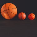 Big and small basketball balls on black background