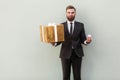 Big or small? Choise concept. Businessman holding different boxes