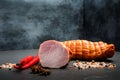 Big and small chunks of smoked ham with spices and two chili Royalty Free Stock Photo