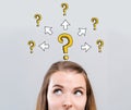 Big and small question marks with arrows with young woman Royalty Free Stock Photo