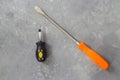 Big and small screwdrivers on a stone background Royalty Free Stock Photo