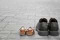 Big and small shoes on pavement outdoors. Father's day